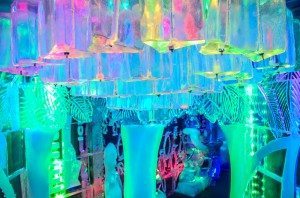 The ice chandelier plays up the colors of the neon light show.