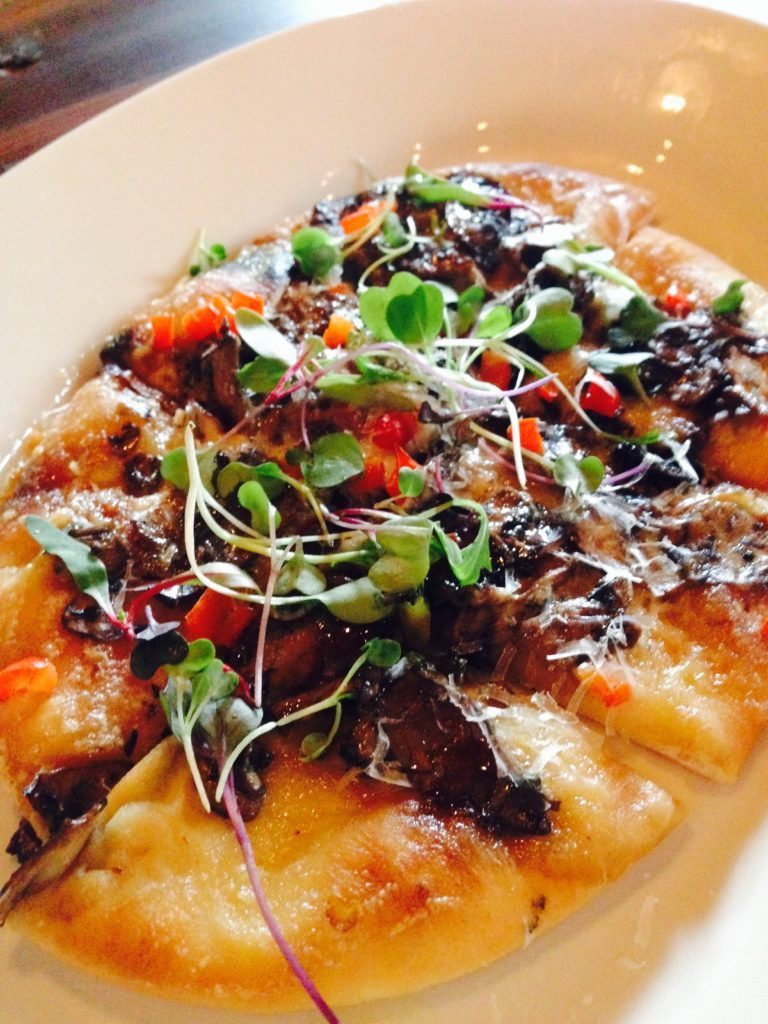 COCA CON SETAS flatbread with wood grilled local mushrooms, zamorano cheese, allioli and truffle oil.