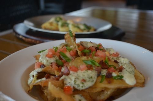J.T.’s Kettle Chips: Crispy Potato Chips Crowned with Gorgonzola Cheese, Bacon, Roma Tomato and Scallions