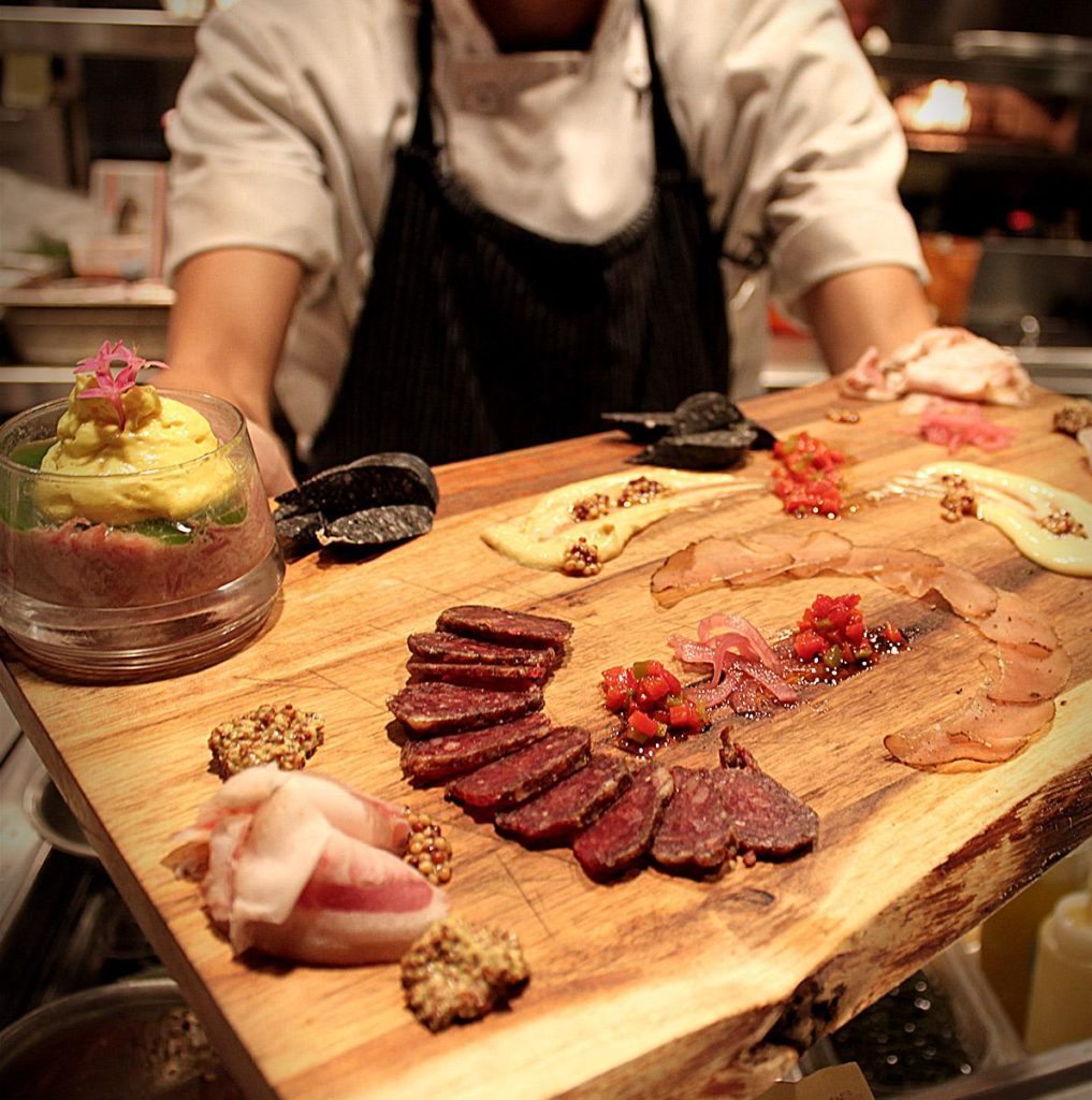 Osprey Tavern's Charcuterie with nduja, chorizo, lonza, charred onion kielbasa, tête de cochon , house pickles, grilled bread. ($18) 