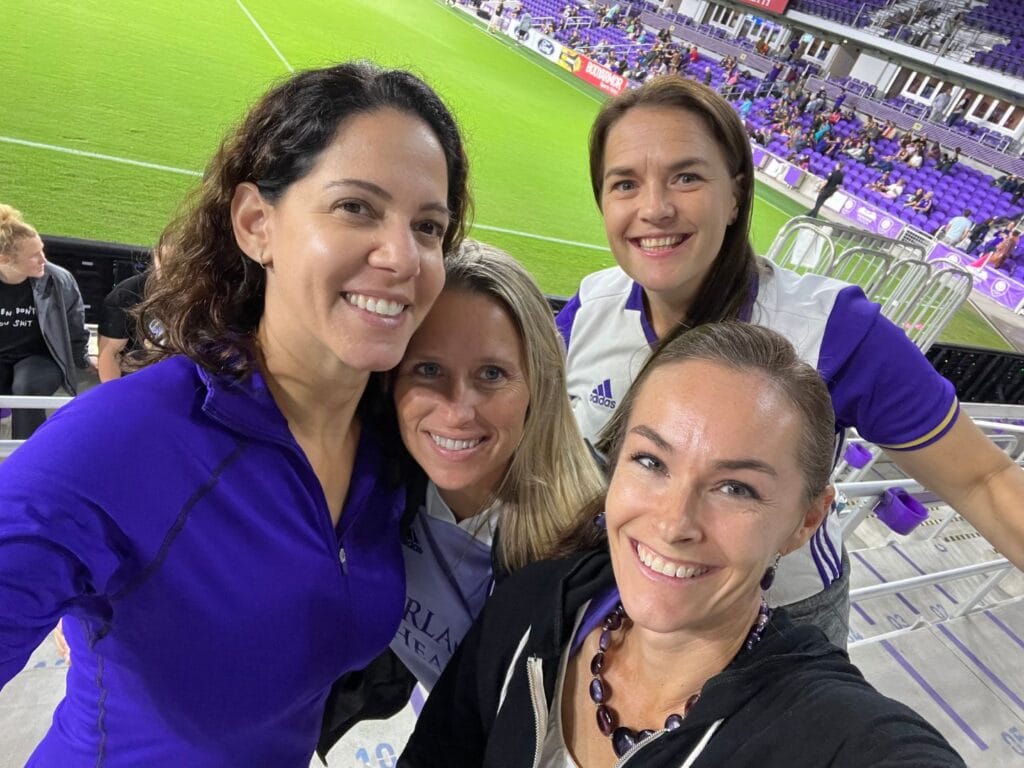 Four women at Orlando Pride soccer game