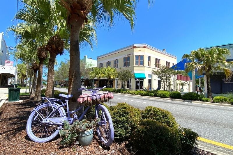 Atlantic Avenue Main Street of Historic Downtown Titusville - with a pastel purple bicycle prop in the foreground