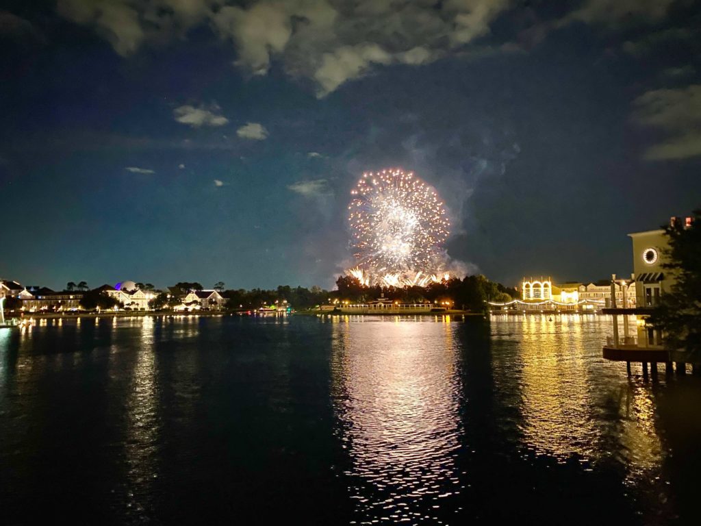 EPCOT Harmonious Fireworks from Boardwalk Resort - large white and gold fireworks reflect on Crescent Lake