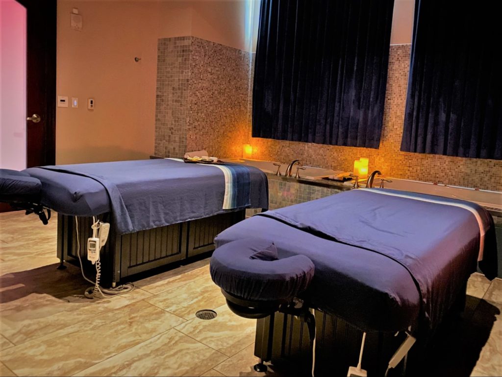 Couples Room Blue Harmony Spa by Wyndham Bonnet Creek features two soaking tubs and warm, soft lighting 