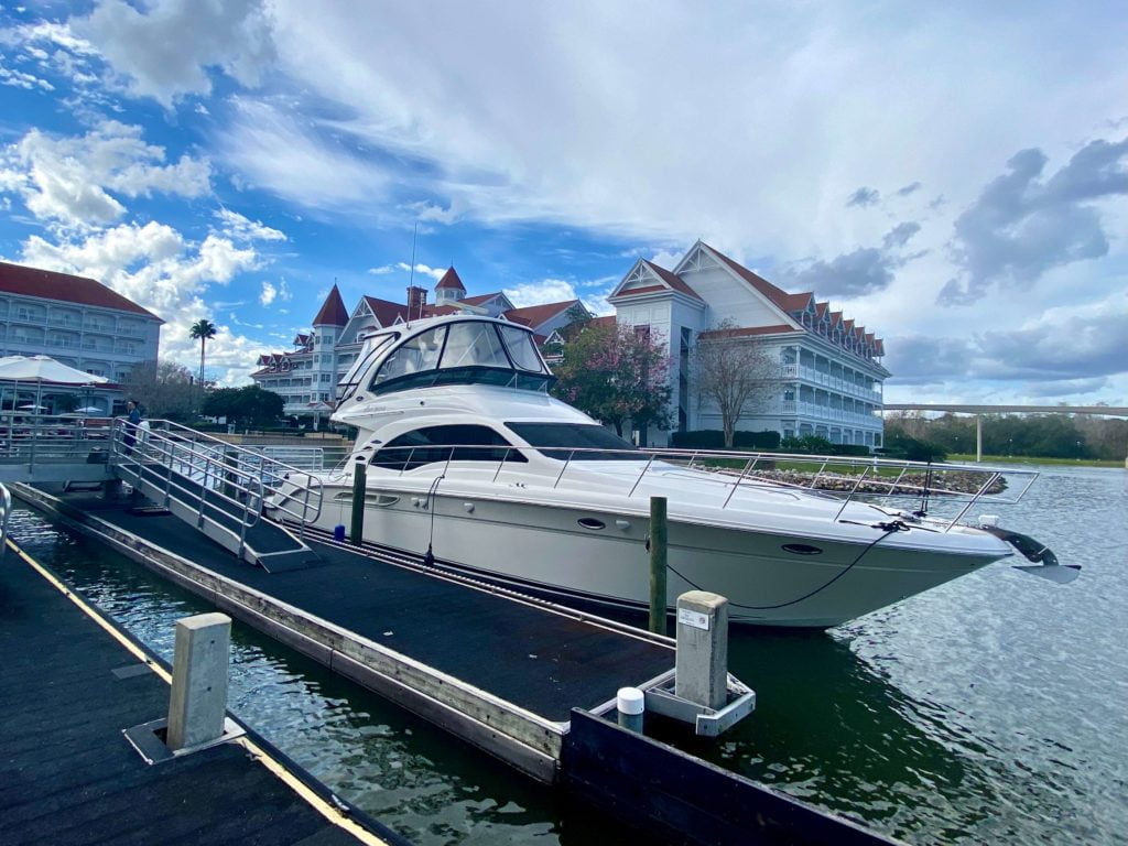 The Grand 1 Yacht at Grand Floridian is a large white yacht. In this photo it is docked at the Grand Floridian resort.