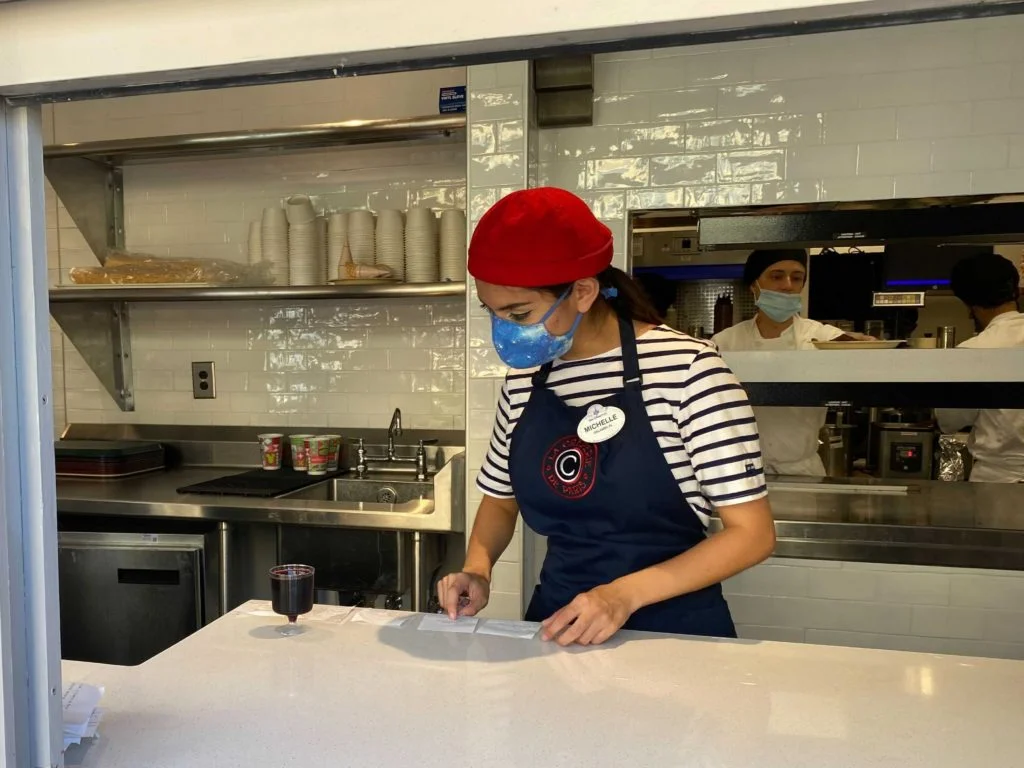 A Cast Member at the France Pavilion prepares an order at the new crepe walk up window