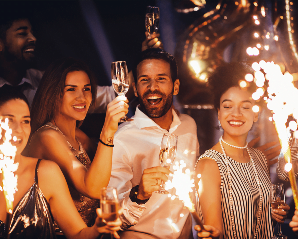 stock photo of adults with sparklers celebrating new years eve