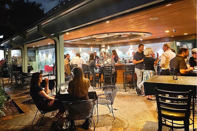 Facing towards the Eden Bar outdoor bar at The Enzian Theater with a crowd at night