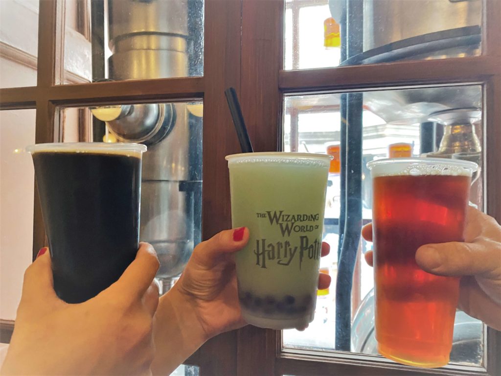 three Drinks at Fountain of Fair Fortune held in front of a window