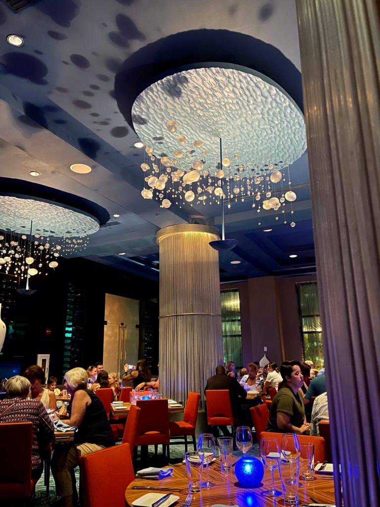 the dining room at todd englishs bluezoo walt disney world feature rich blue and orange tones, with light fixtures that resemble bubbles