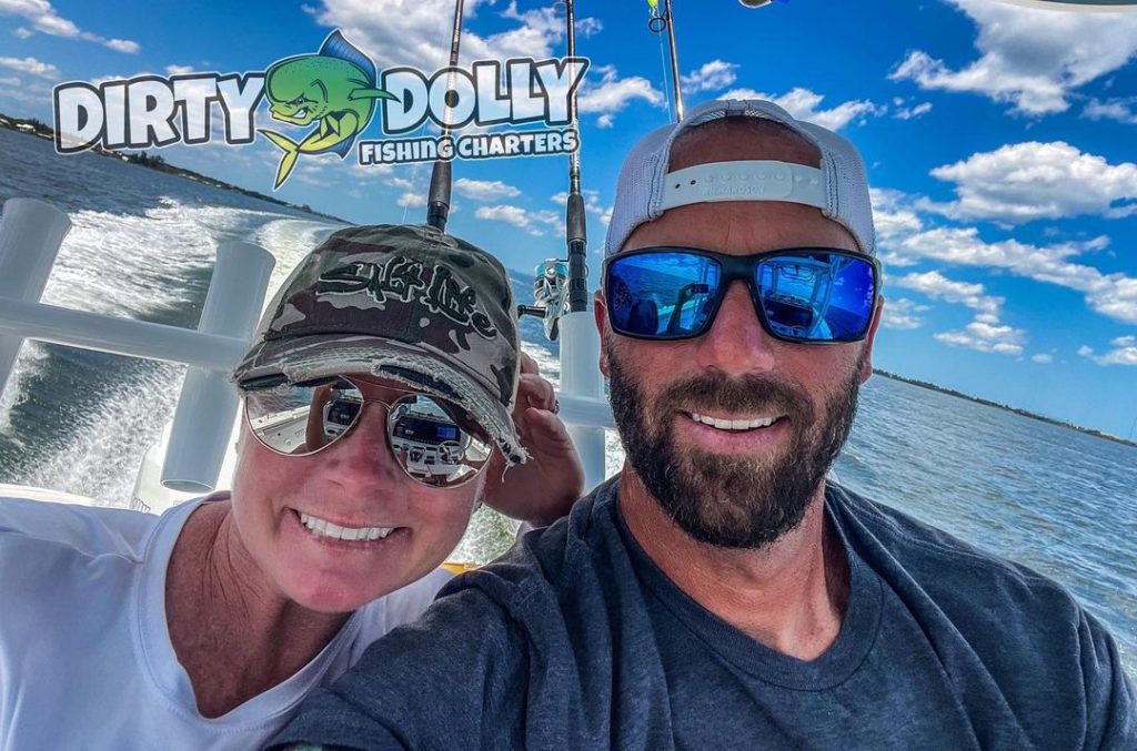 A selfie style photo of a man and woman on Dirty Dolly Fishing Charters 