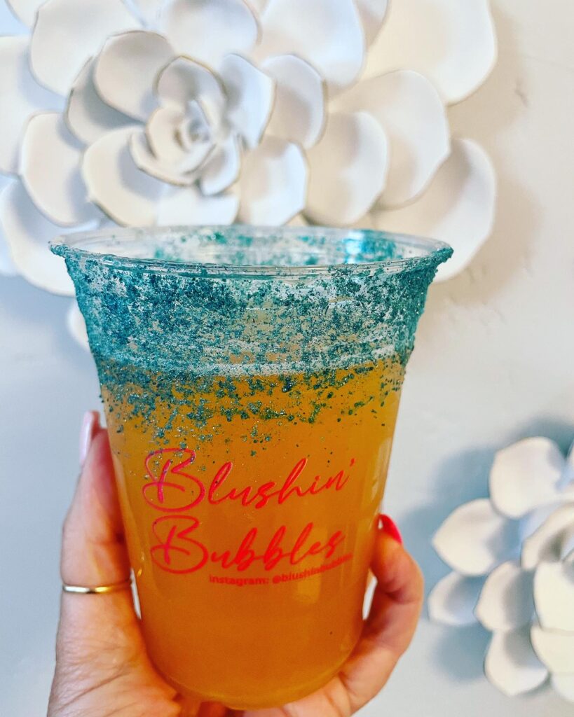 a mimosa in a logo cup for Blushin' Bubbles