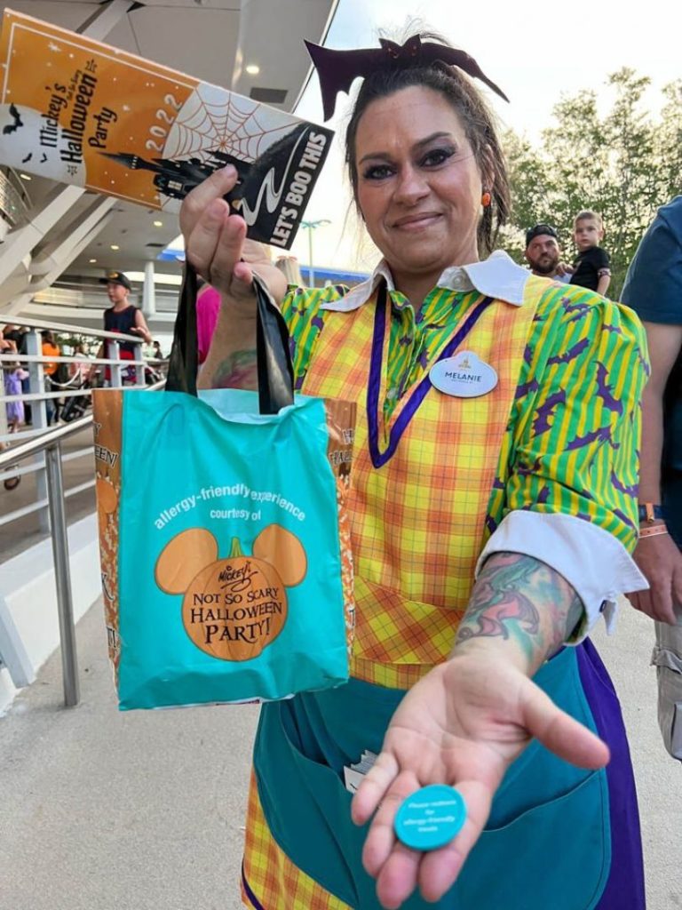 A cast member demonstrates the Allergy-Friendly Trick or Treating at Mickey's Not So Scary Halloween Party 