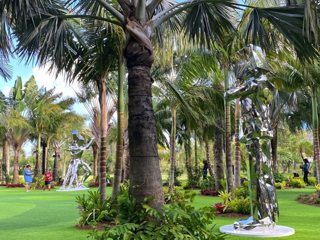 Two tall metallic sculptures are among the Lake Nona Sculpture Garden