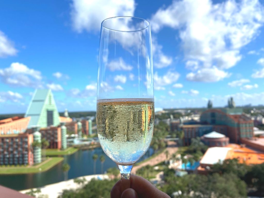 Swan anChampagne glass held up in foreground, from Vue Terrace at Swan Reserve overlooking Swan and Dolphin hotels