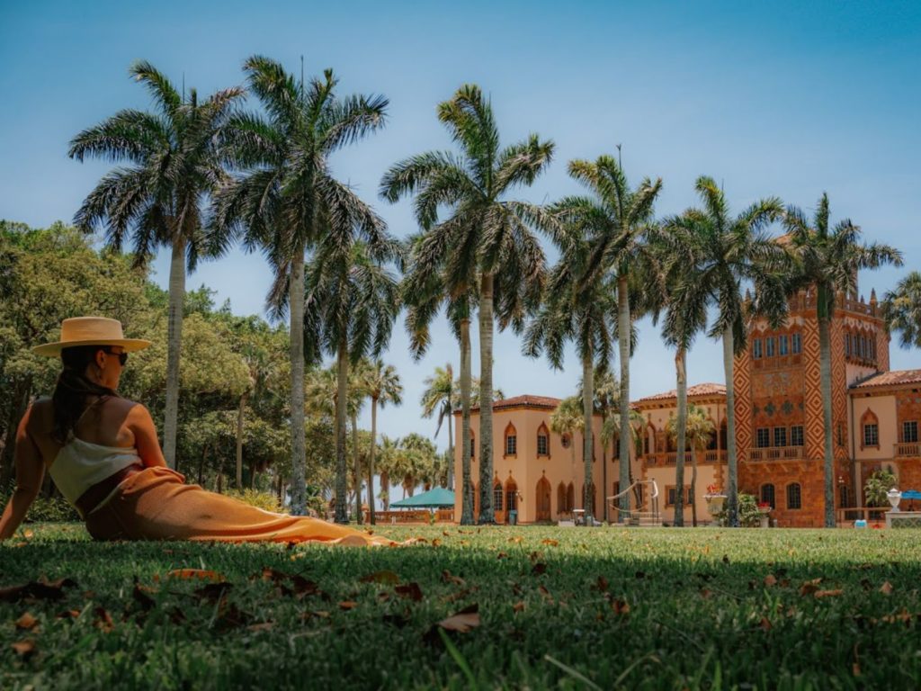 Photographer and Writer Kelsey Glennon sits on the lawn of the The John and Mable Ringling Museum during a Lido Key Getaway 