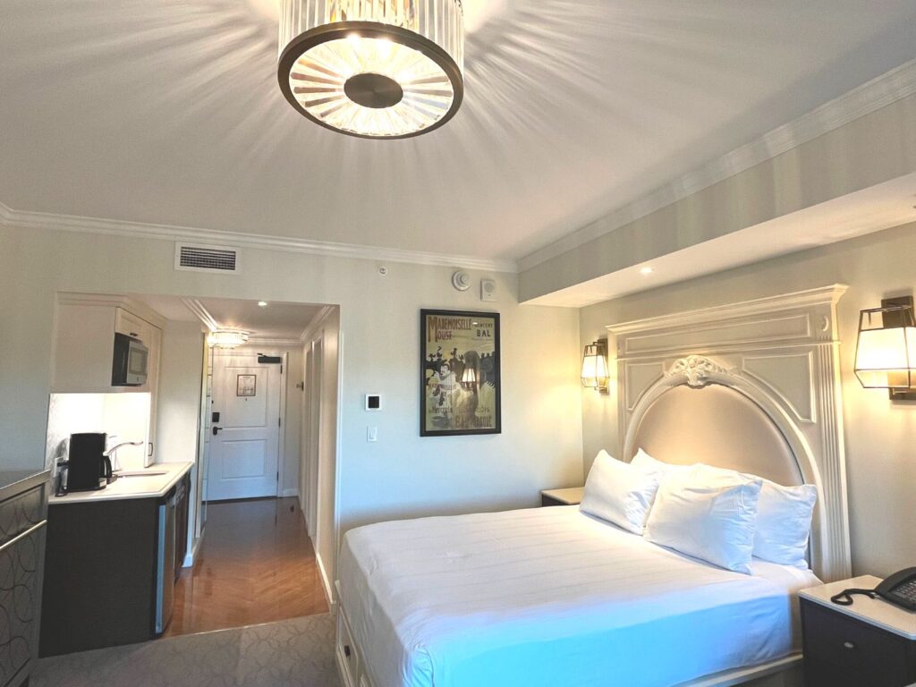 Deluxe Studio at Disney's Riviera Resort -guest room with white linen bed and kitchenette