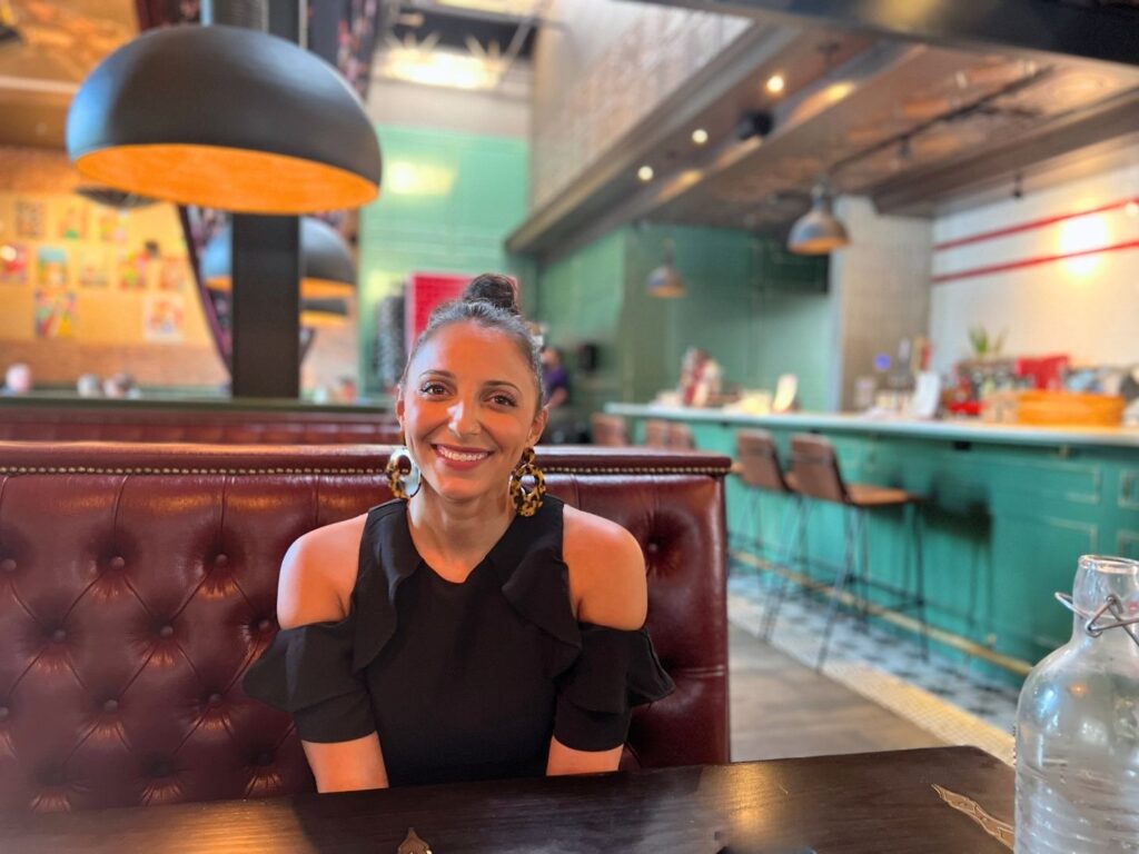 writer alayna curry sits at dining table at mia's italian kitchen in orlando