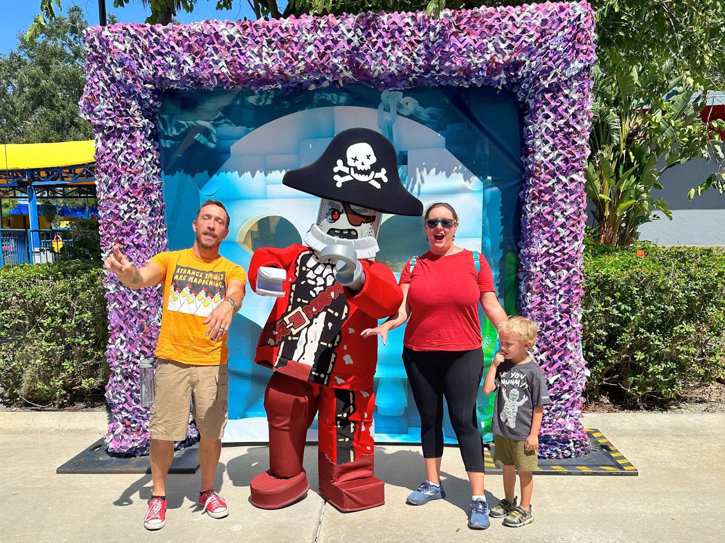 a mom, dad, and young son meet Zombie Pirate Character at Pirates' Cove Legoland Florida Brick or Treat -