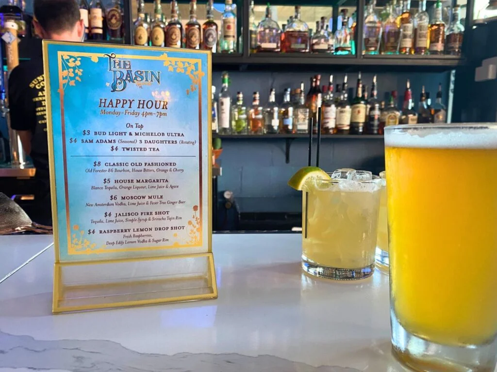 sign with info about Happy Hour at The Basin Sanford