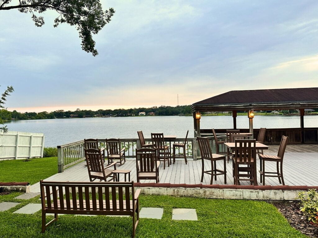 Enzo's on the Lake at Sunset with benches and tables