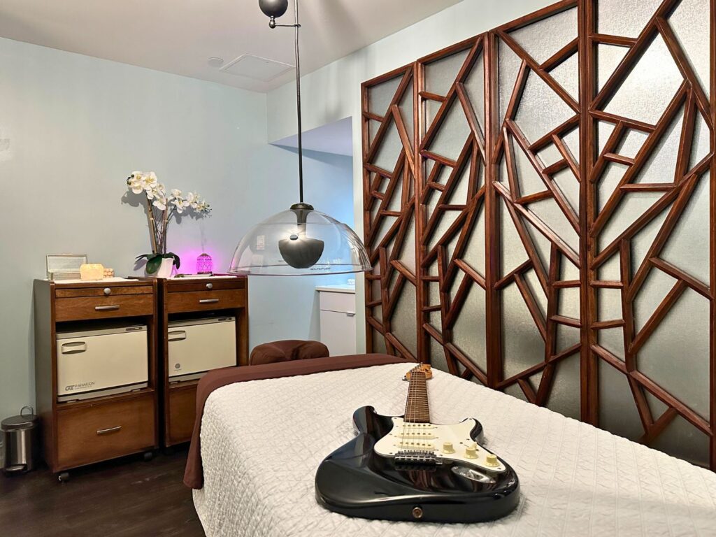 a guitar lays on a massage table at the Rhythm and Motion Room Rock Spa Hard Rock Hotel Daytona Beach 