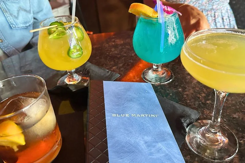 Specialty cocktails and menu on table at Blue Martini