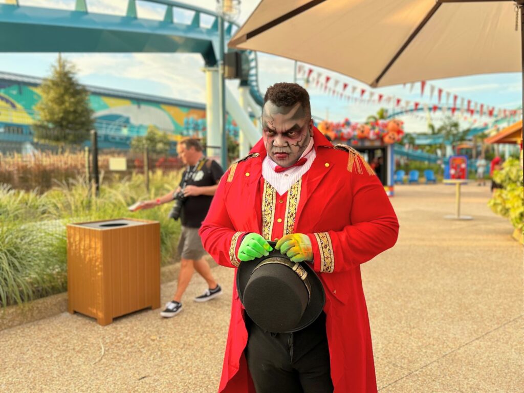 a scary performer waits for guests in the CarnEvil Pier Scare Zone Howl-O-Scream 2023 SeaWorld -
