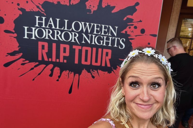 author taking a selfie in front of Halloween Horror Night RIP Tour Sign