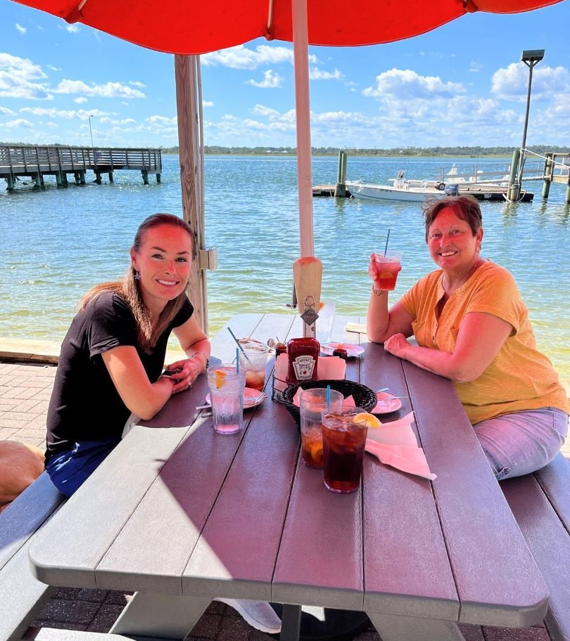 two women sit at a waterfront table at Aunt Kate's St. Augustine