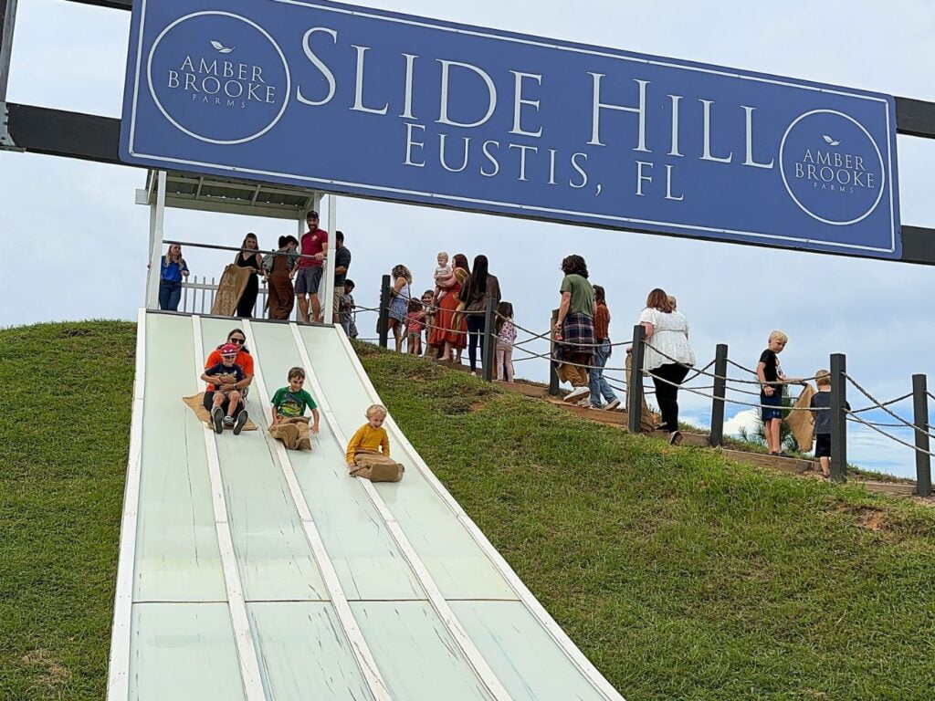 Families Slide Down Hill at Amber Brooke Farms Eustis Near Orlando 