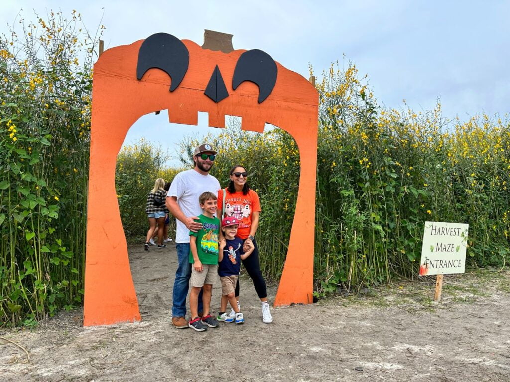 Family of 4 poses at crop maze at Amber Brooke Farms Eustis Near Orlando 