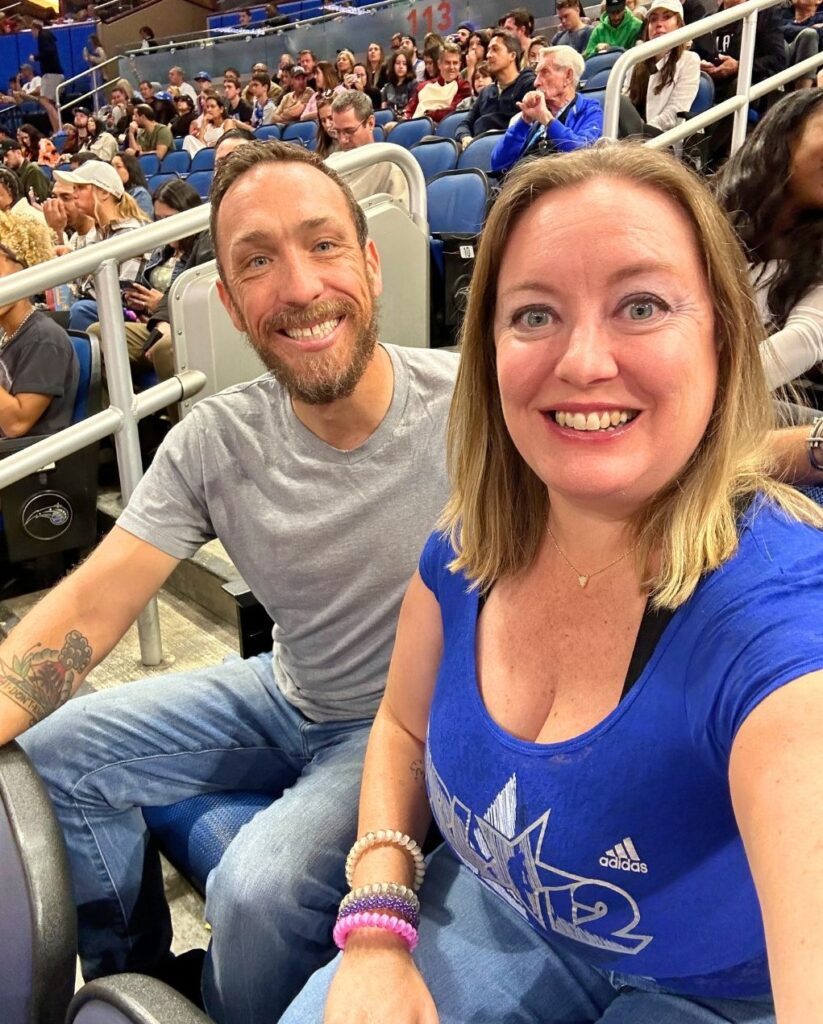 a husband and wife take a selfie during Orlando Magic Game Date Night