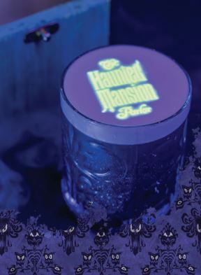 Signature Beverage at Haunted Mansion Parlor with black light effect - image from Disney Parks Blog