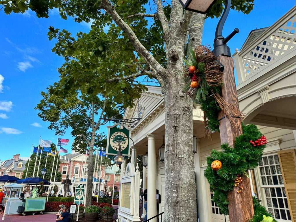 Christmas Garland around lamp posts at Liberty Square Magic Kingdom