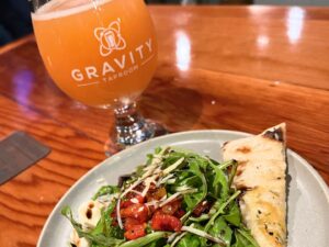 Gravity Taproom glass of beer and Mount Arugula salad
