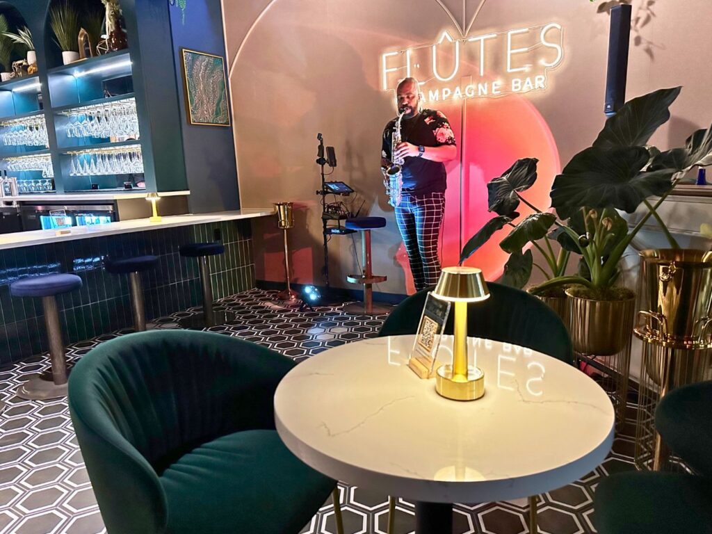 Image of man playing the saxophone at Flutes Champagne Bar