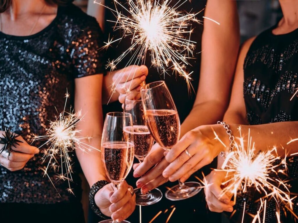 Image of Five People Doing a New Year's Champagne Toast with Sparklers