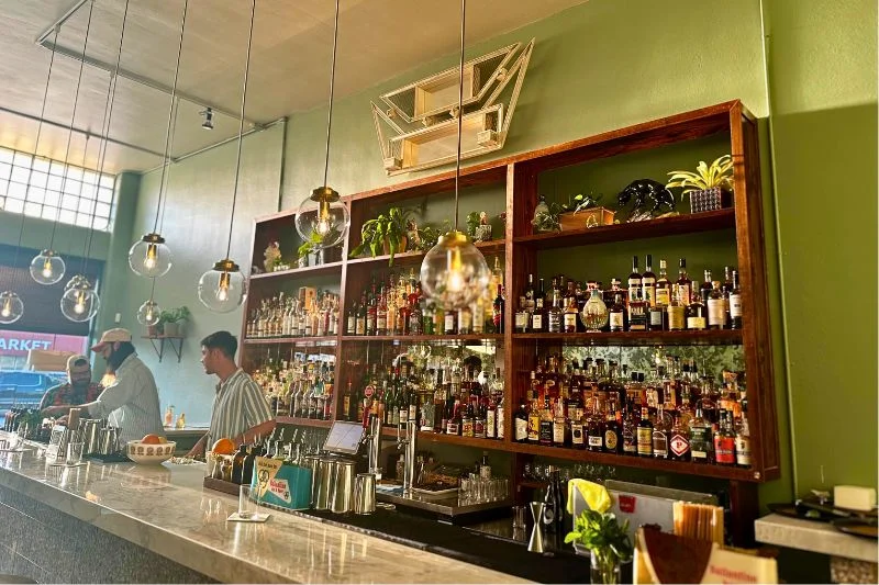 sitting at the bar of dba bar in orlando at sunset