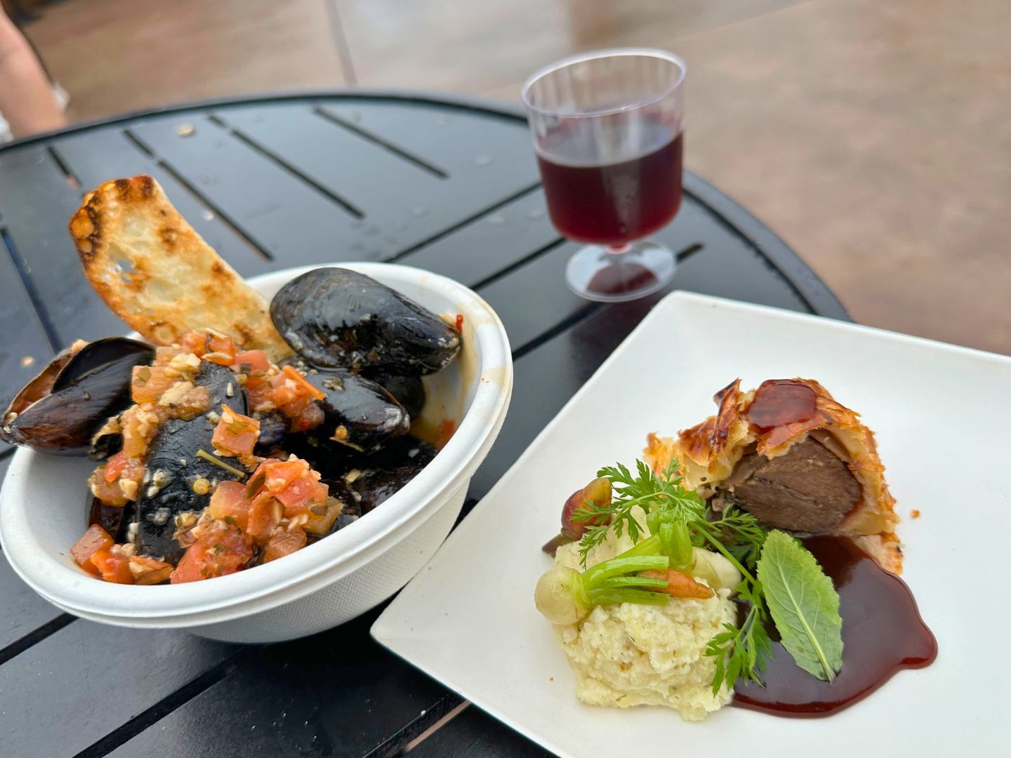 Beef Wellington and Mussels on a table at EPCOT Festival of the Arts 2024 