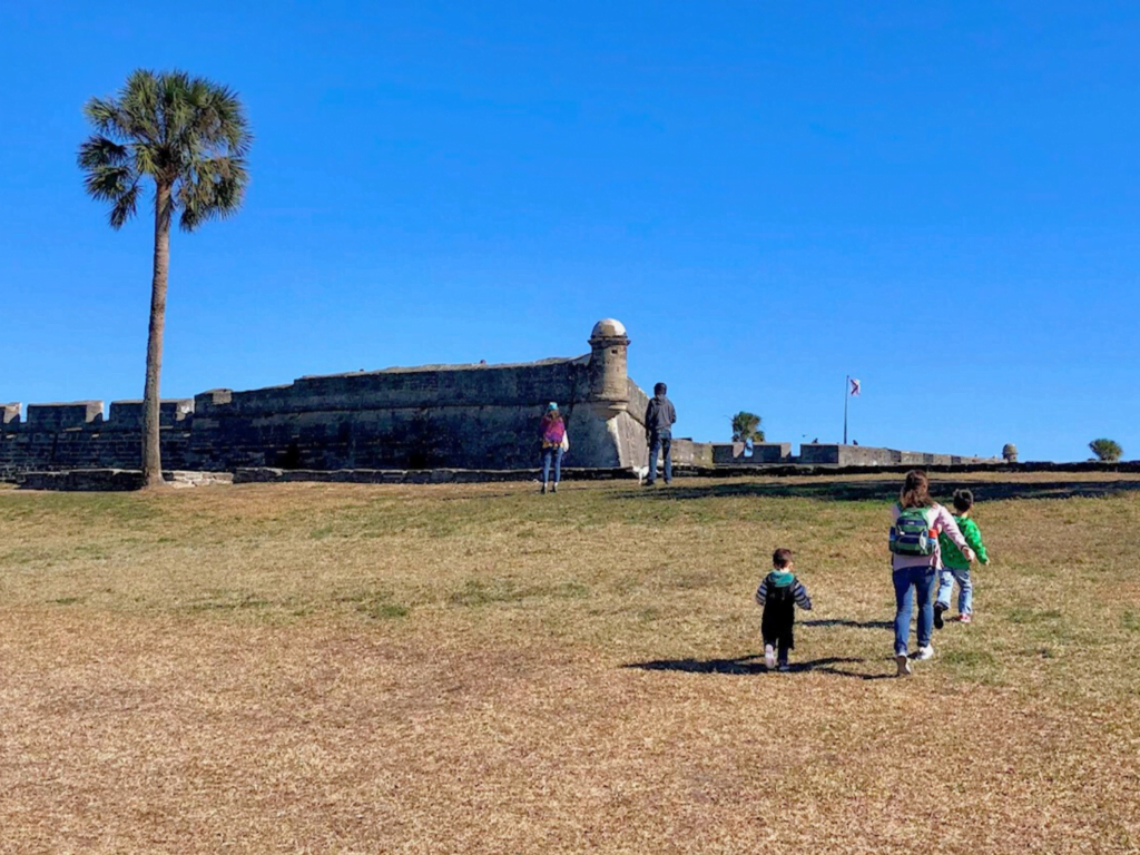 3 adults and 2 children Walking Toward Castillo de San Marcos National Monument