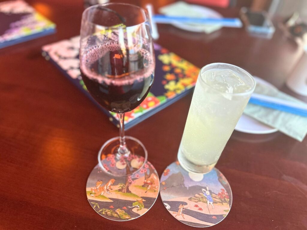 Image of a glass of red wine and a cocktail at EPCOT’s Shiki-Sai