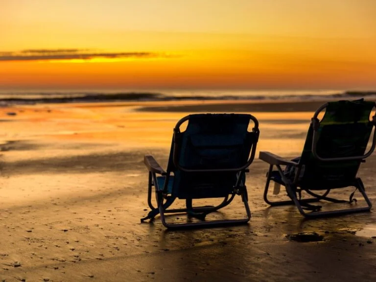 Two beach chairs at sunset