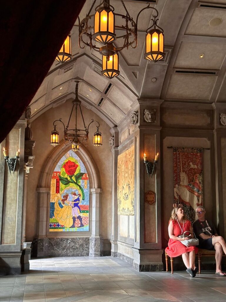 a couple laughs together at Be Our Guest Lobby at Magic Kingdom 