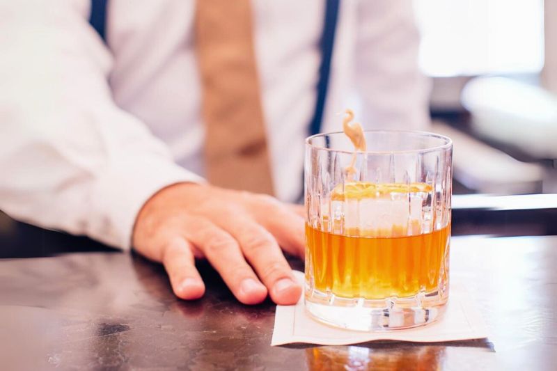 dapper dressed bartender serving a drink during a derby day events in orlando