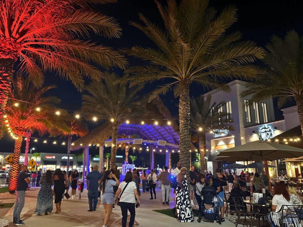 Guests enjoying Sunset Walk Promenade in Kissimmee at night with Free Parking and Admission 