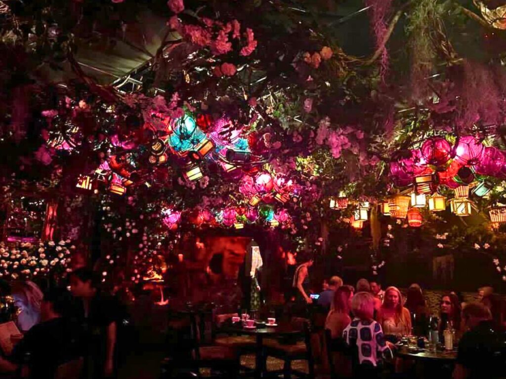 dining area of Roka Hula tiki bar with colorful lights and tropical tiki decorations