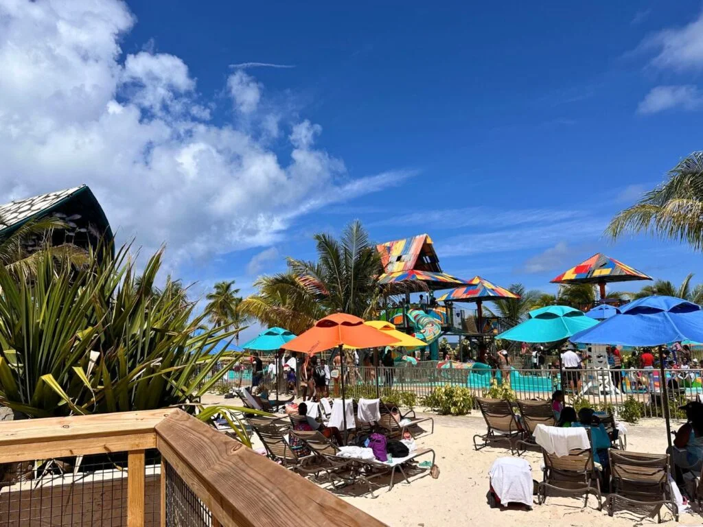 Rush Out Gush Out Water Play Area for Families at Disney Lookout Cay as seen from elevated boardwalk and beach chairs