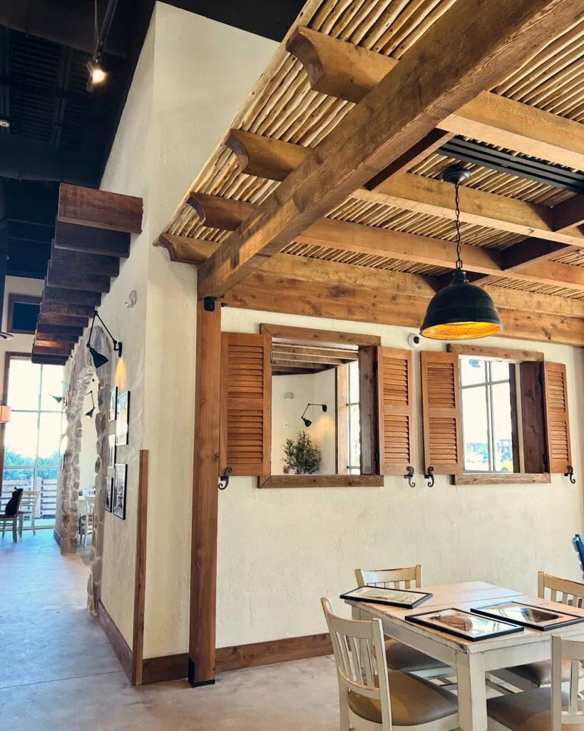 Parea Greek Tavern dining room with white walls and wood accents - @Parea_greek_tavern