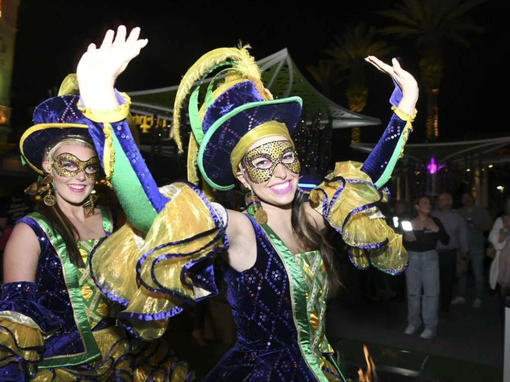 Mardi Gras Event Pardi Gras at Pointe Orlando two young ladies in costumes